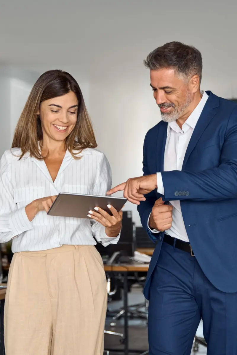 A businesswoman walking with a businessman